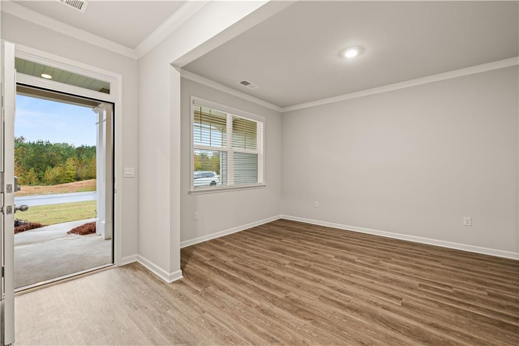 1171 Kingston Road Buckhead, GA 30625 - Photo 7 of 34 an empty room with wooden floor and windows
