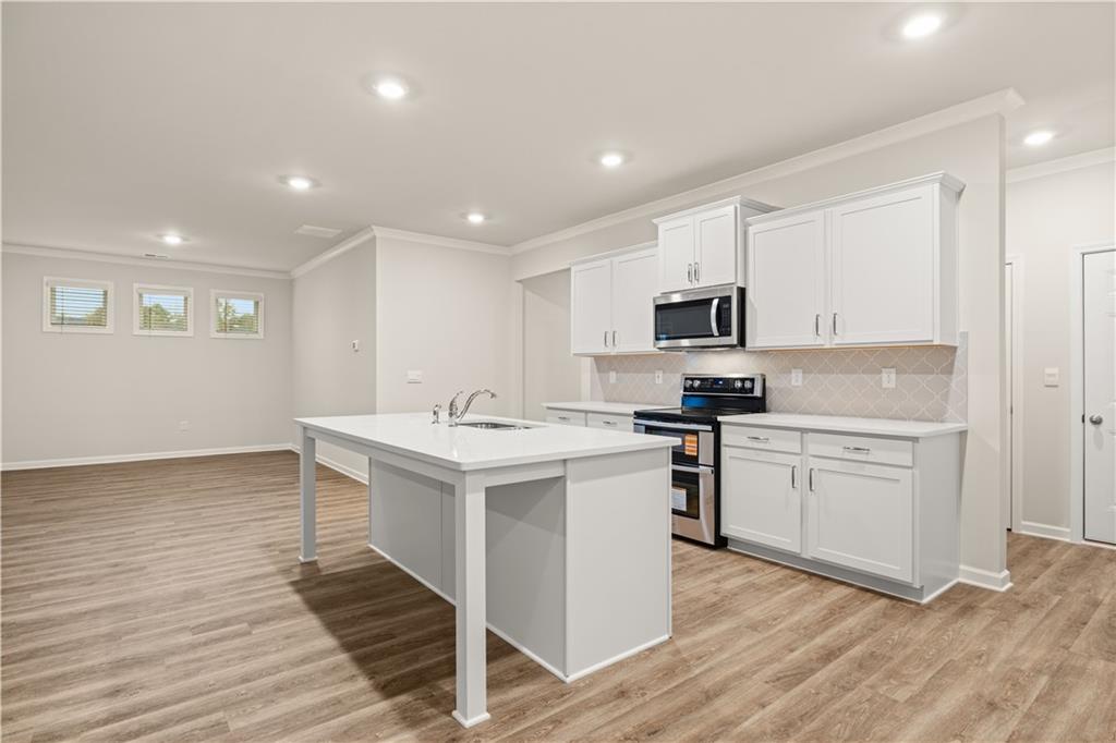 1171 Kingston Road Buckhead, GA 30625 - Photo 10 of 34 a kitchen with a sink stainless steel appliances and white cabinets