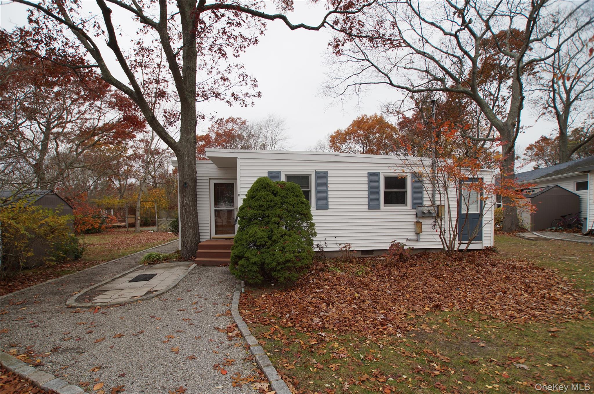 12 East Tiana Road, Unit 6 Hampton Bays, NY 11946 - Photo 2 of 9 a view of a house with a yard