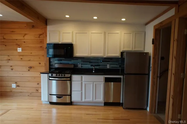 a kitchen with stainless steel appliances granite countertop a refrigerator and a stove