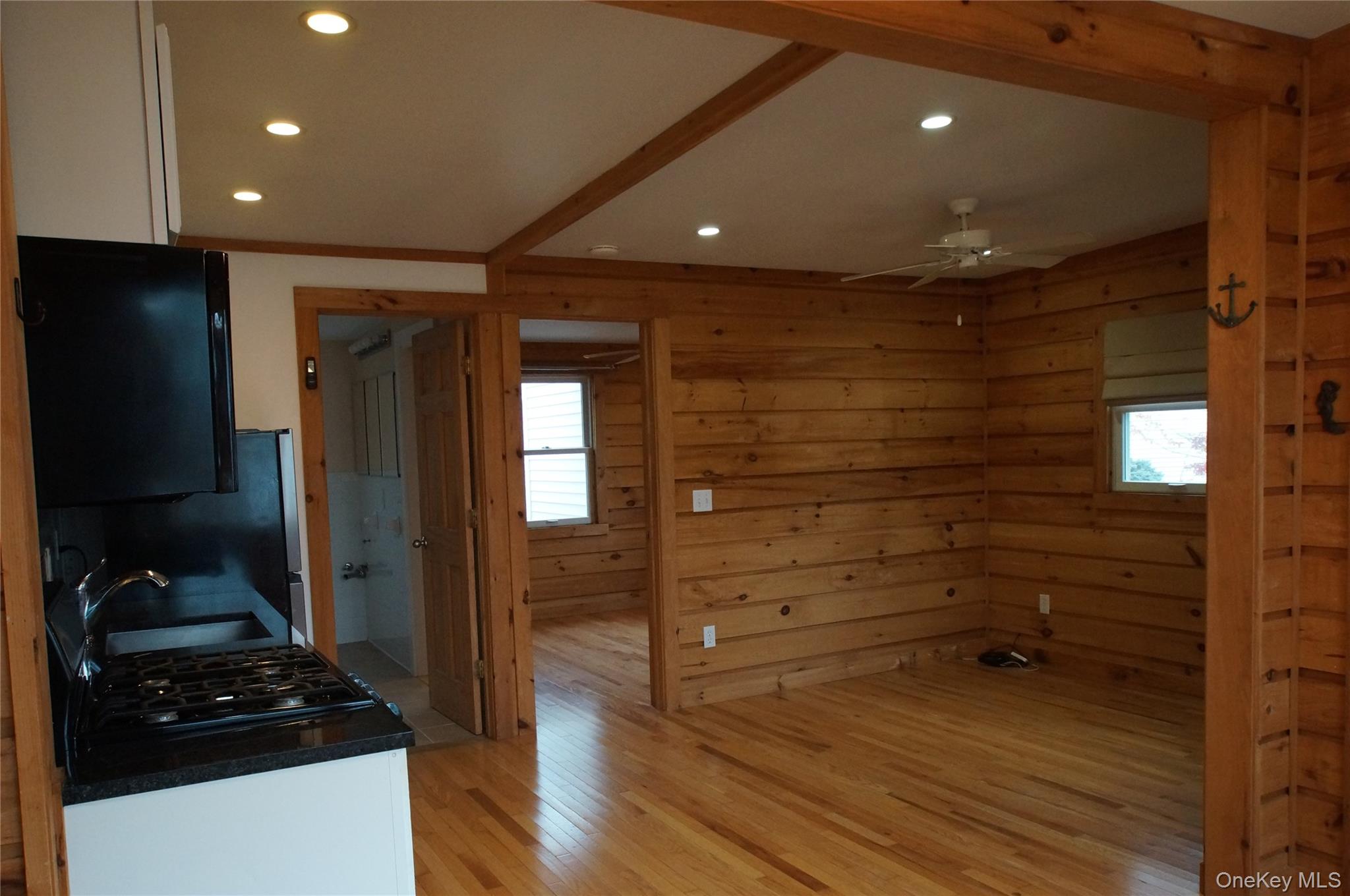 12 East Tiana Road, Unit 6 Hampton Bays, NY 11946 - Photo 5 of 9 a bathroom with a glass door shower and a sink