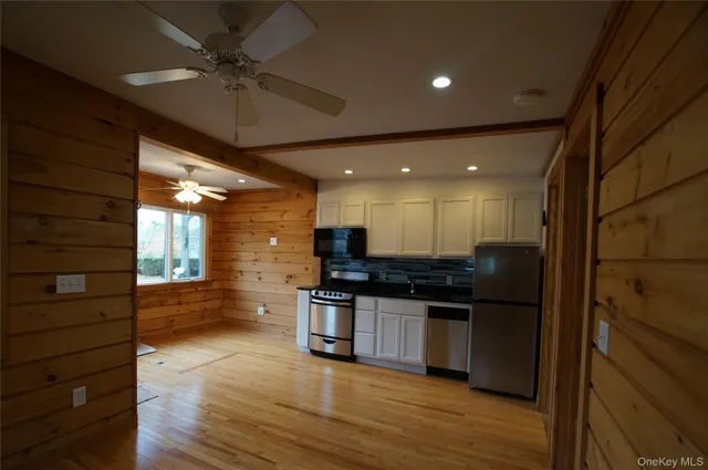 a kitchen with stainless steel appliances granite countertop a stove and a refrigerator