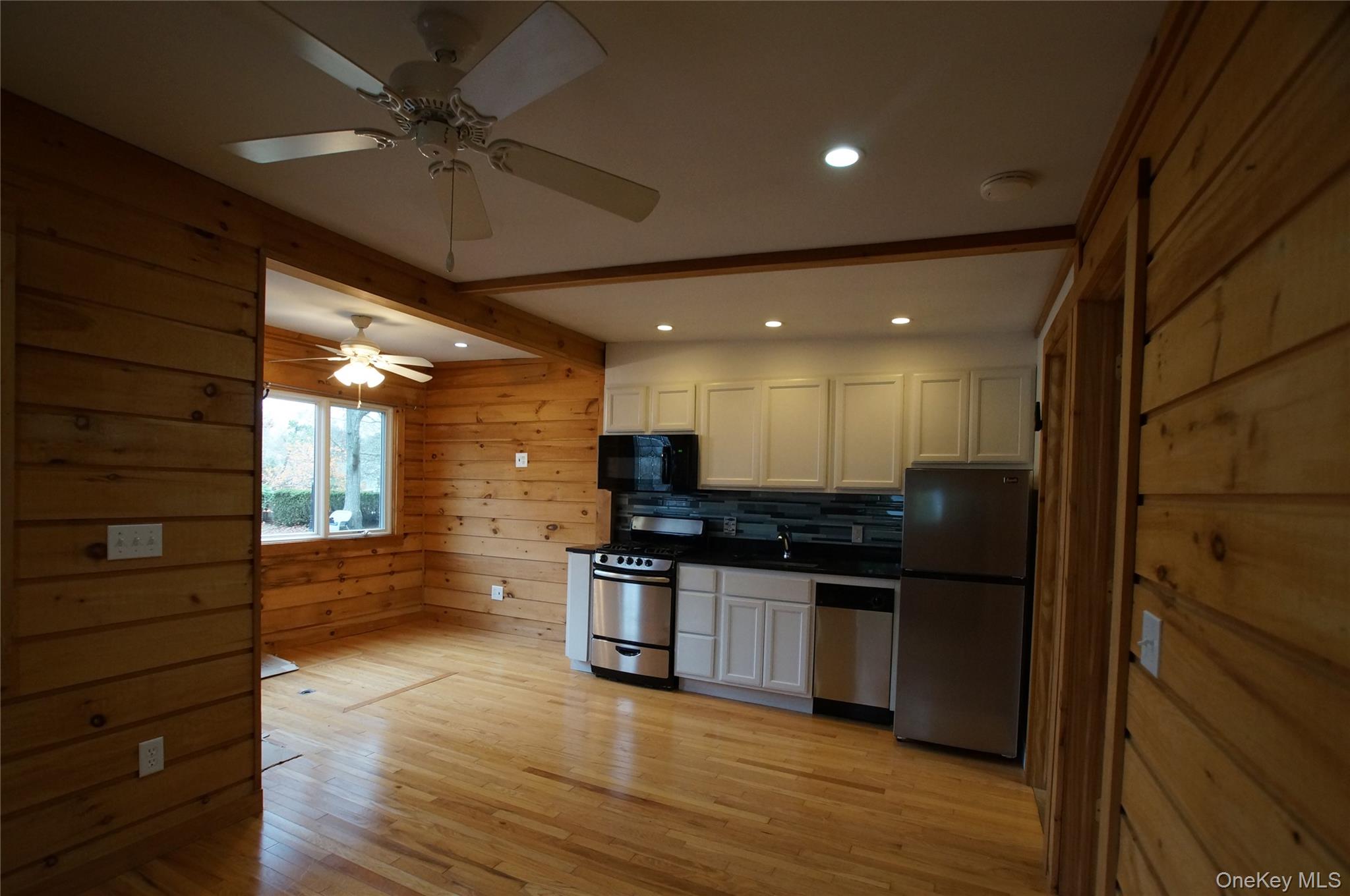 12 East Tiana Road, Unit 6 Hampton Bays, NY 11946 - Photo 9 of 9 a kitchen with stainless steel appliances granite countertop a stove and a refrigerator