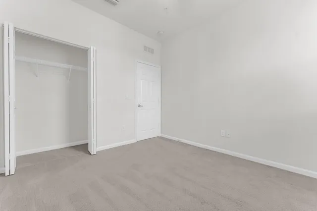 a bathroom with a granite countertop toilet a sink and a bathtub