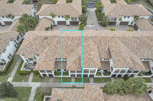 an aerial view of a house with a yard