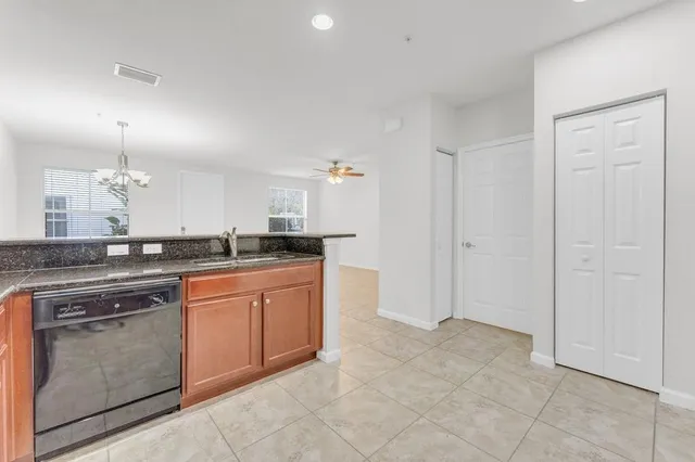 a large kitchen with cabinets and stainless steel appliances