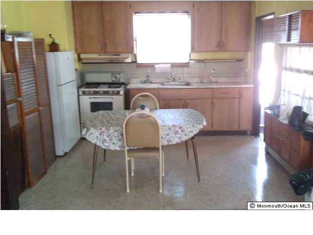 160 Metedeconk Road Brick, NJ 08723 - Photo 3 of 3 a kitchen with a table chairs refrigerator and window