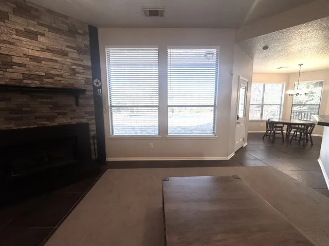 a living room with furniture wooden floor and a fireplace