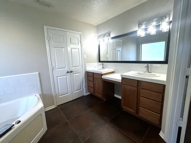 a bathroom with a sink vanity and mirror