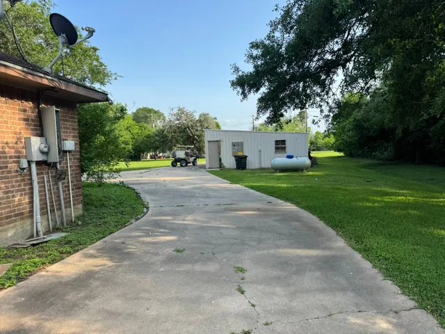 a front view of a house with yard and green space