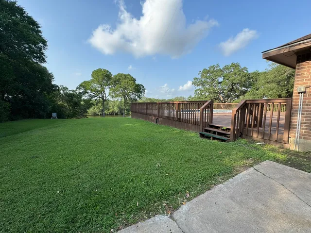 a view of a backyard with sitting area