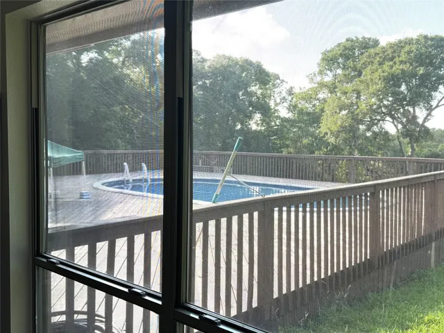 a view of roof deck with wooden floor and fence