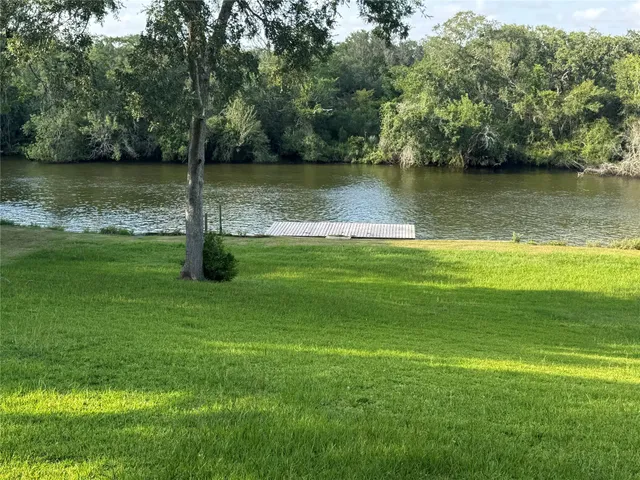 a view of a water pond with green space