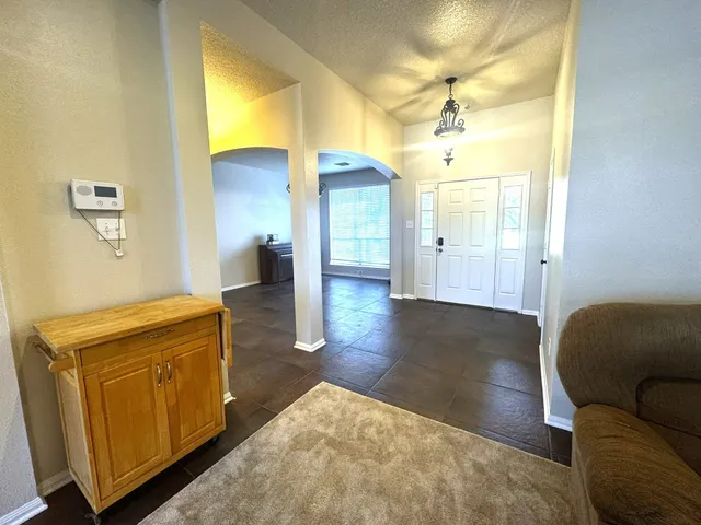 a view of a livingroom with wooden floor and a ceiling fan