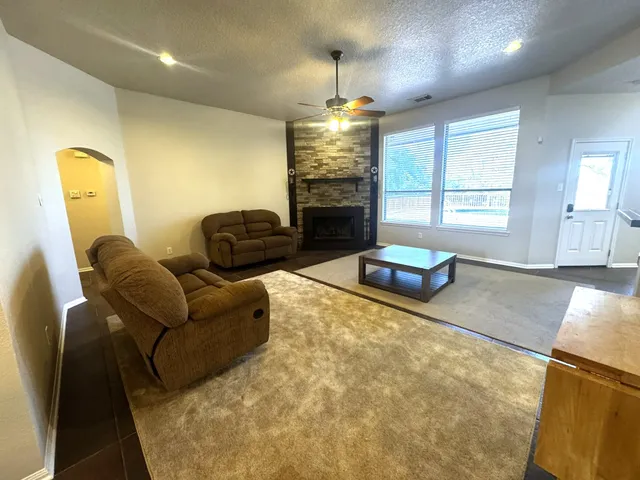 a living room with furniture and a chandelier