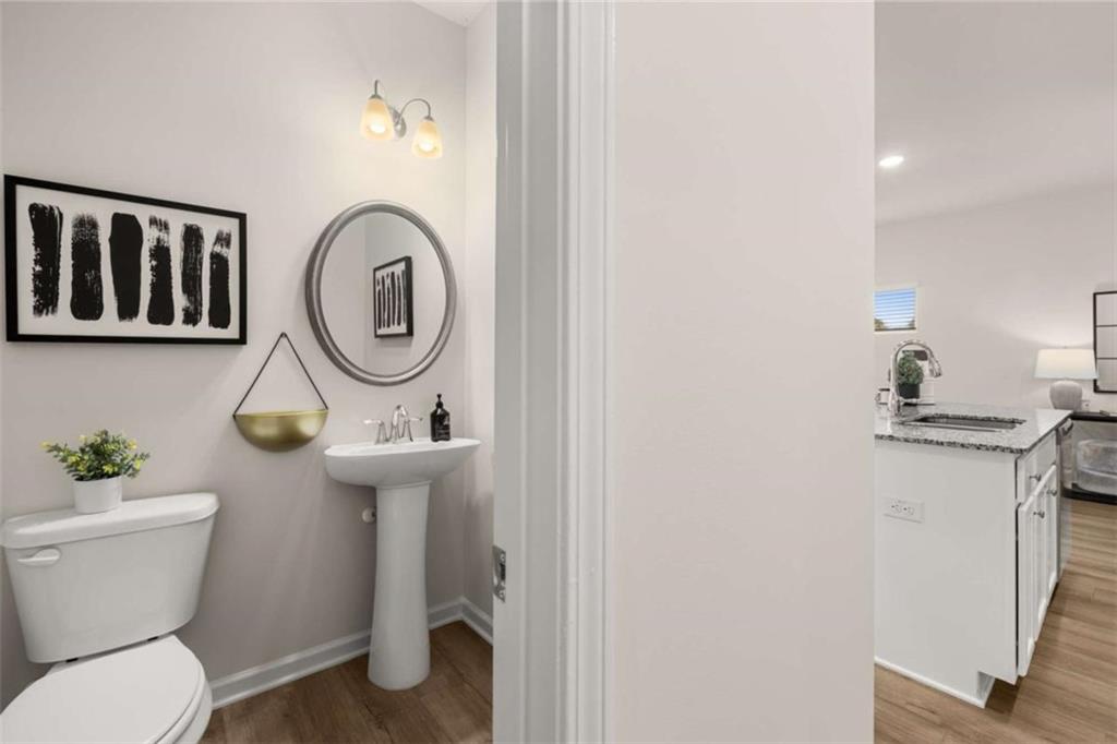 1038 Merritt Drive, Unit 20 Villa Rica, GA 30180 - Photo 25 of 43 a bathroom with a toilet sink and mirror