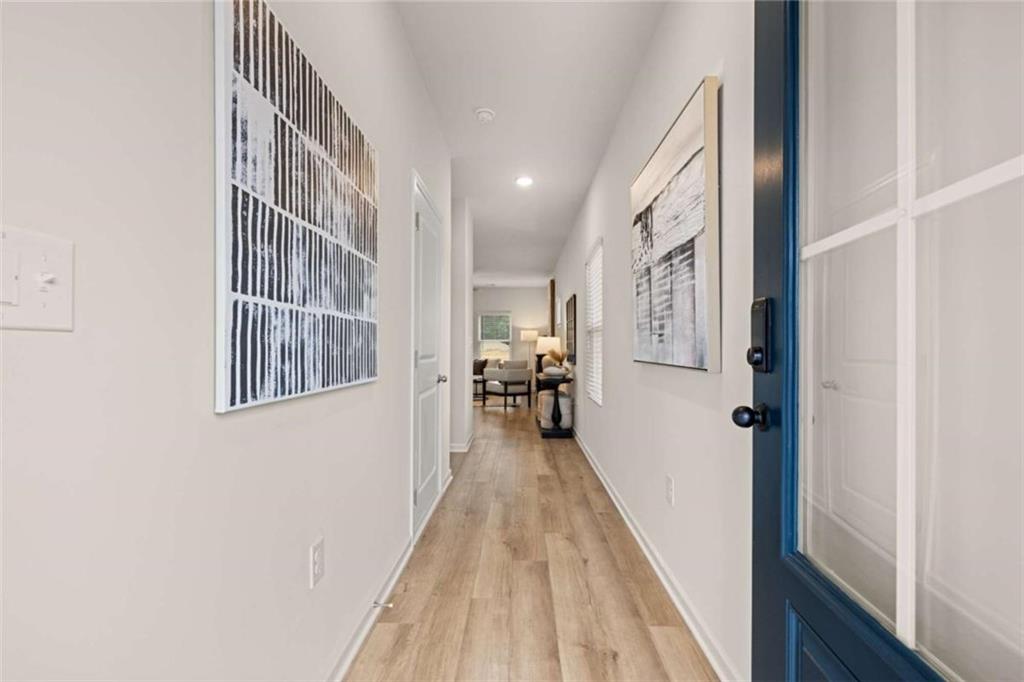 1038 Merritt Drive, Unit 20 Villa Rica, GA 30180 - Photo 38 of 43 a view of a hallway with wooden floor and staircase