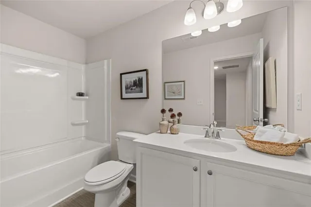 a bathroom with a sink toilet tub and shower