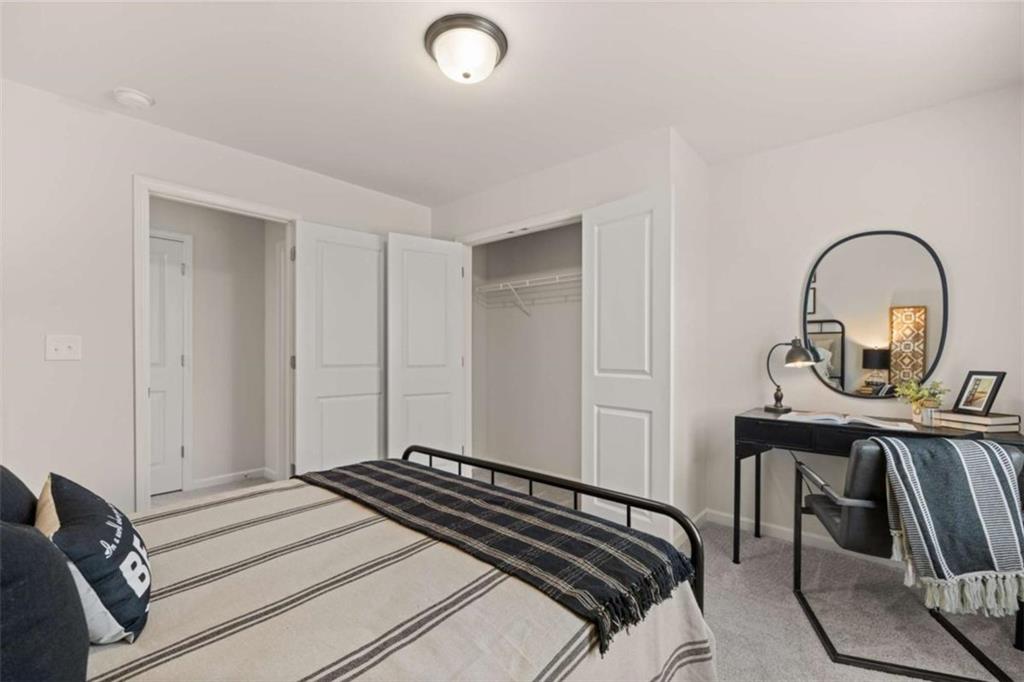 1038 Merritt Drive, Unit 20 Villa Rica, GA 30180 - Photo 10 of 43 a bedroom with a bed and a dresser