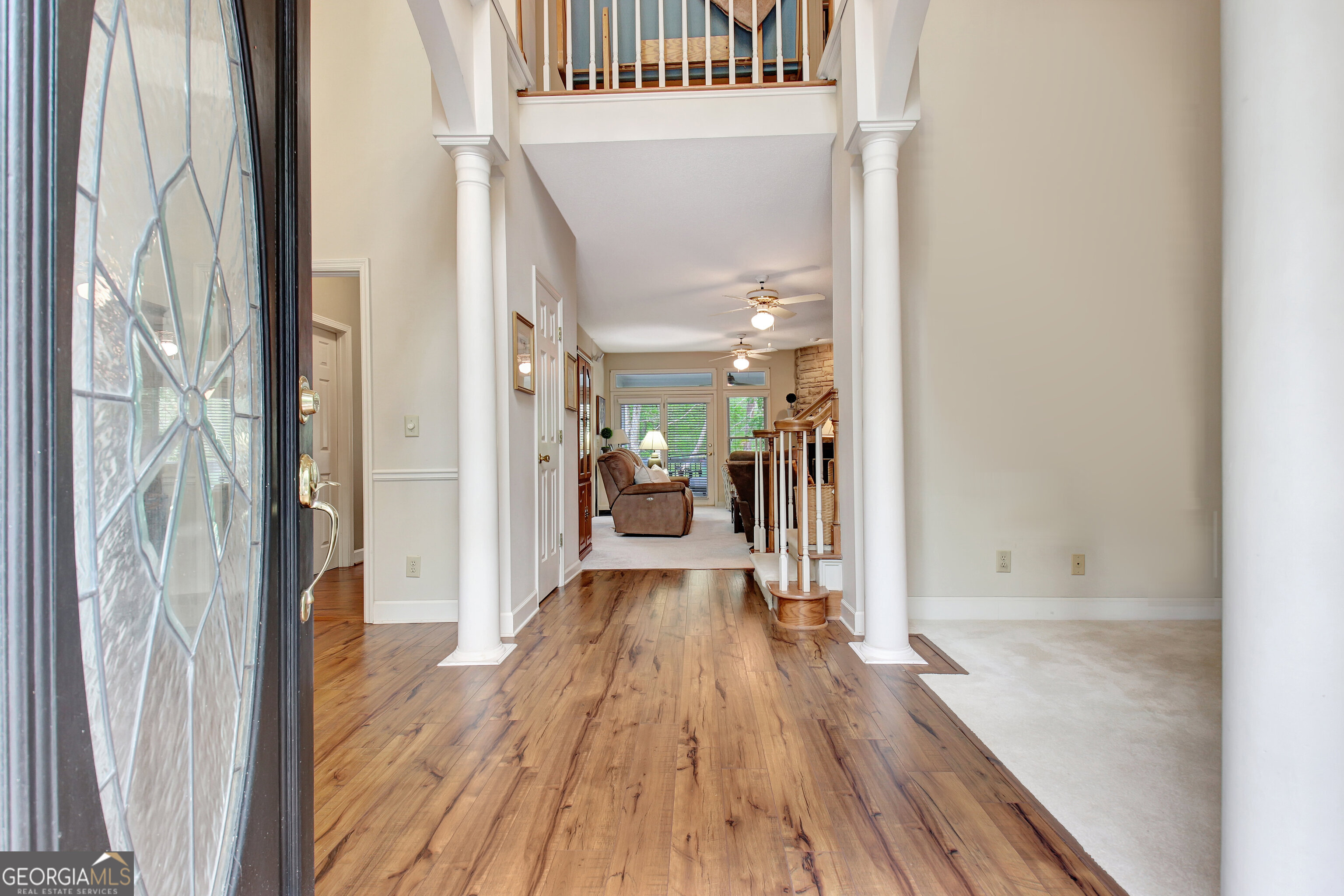110 Sunset Court Senoia, GA 30276 - Photo 13 of 118 a view of a hallway with wooden floor and a living room