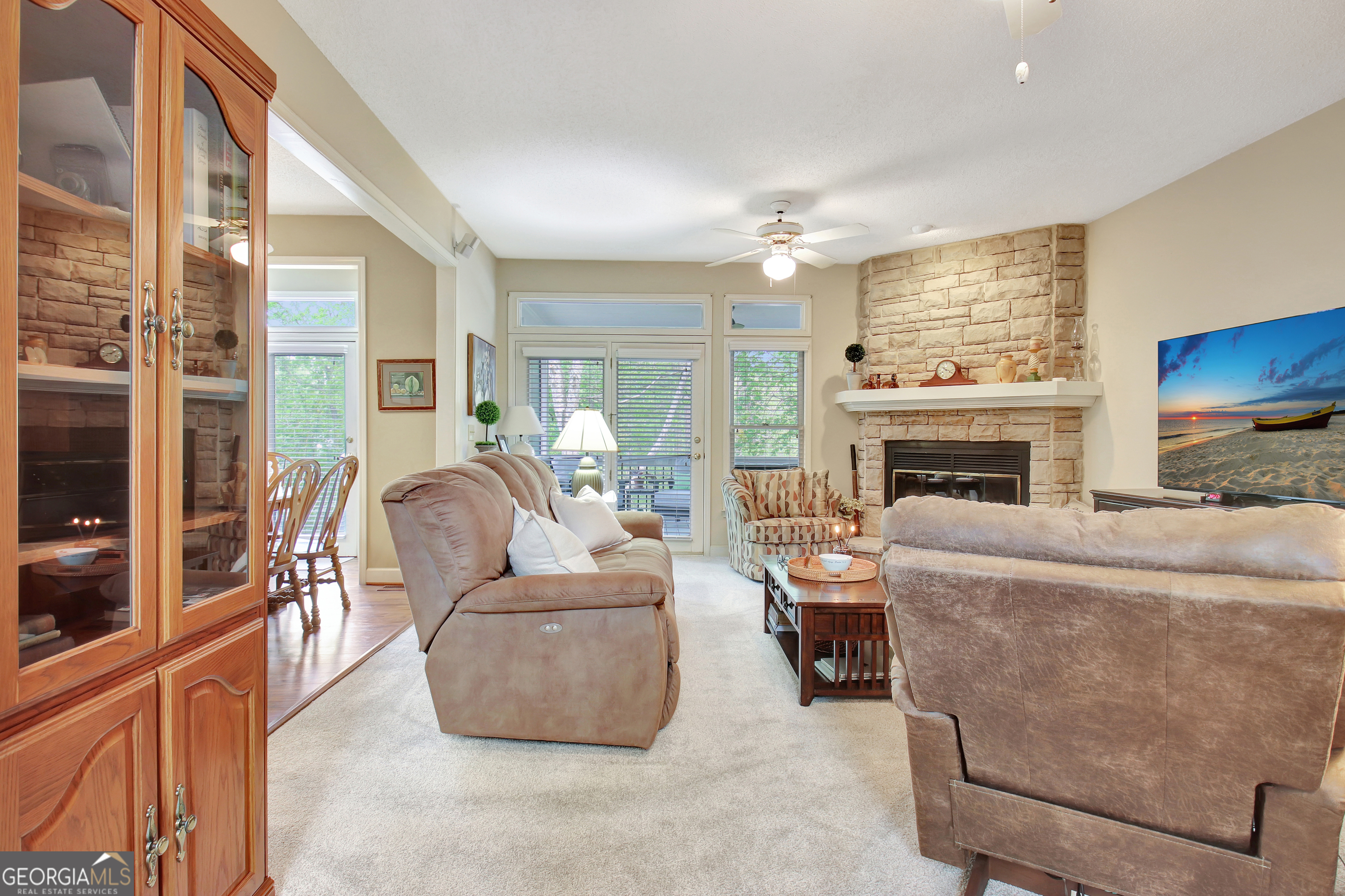 110 Sunset Court Senoia, GA 30276 - Photo 26 of 118 a living room with furniture a fireplace and a flat screen tv