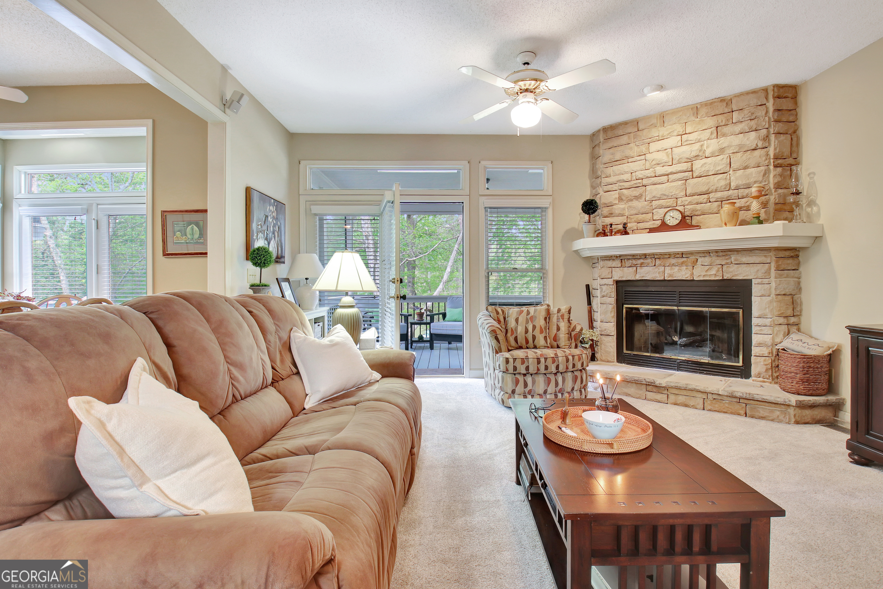 110 Sunset Court Senoia, GA 30276 - Photo 28 of 118 a living room with furniture a fireplace and a large window