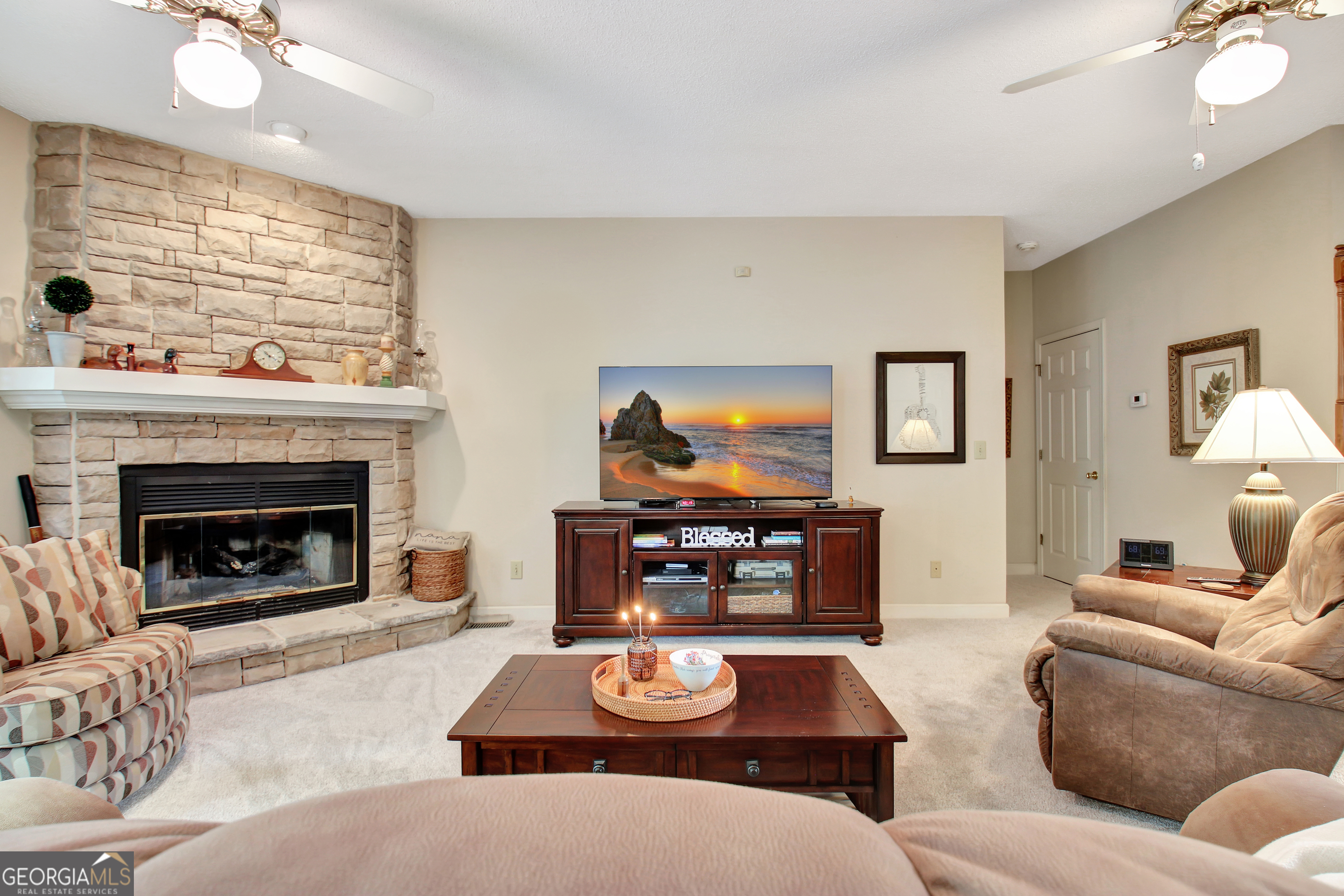 110 Sunset Court Senoia, GA 30276 - Photo 29 of 118 a living room with furniture and a fireplace