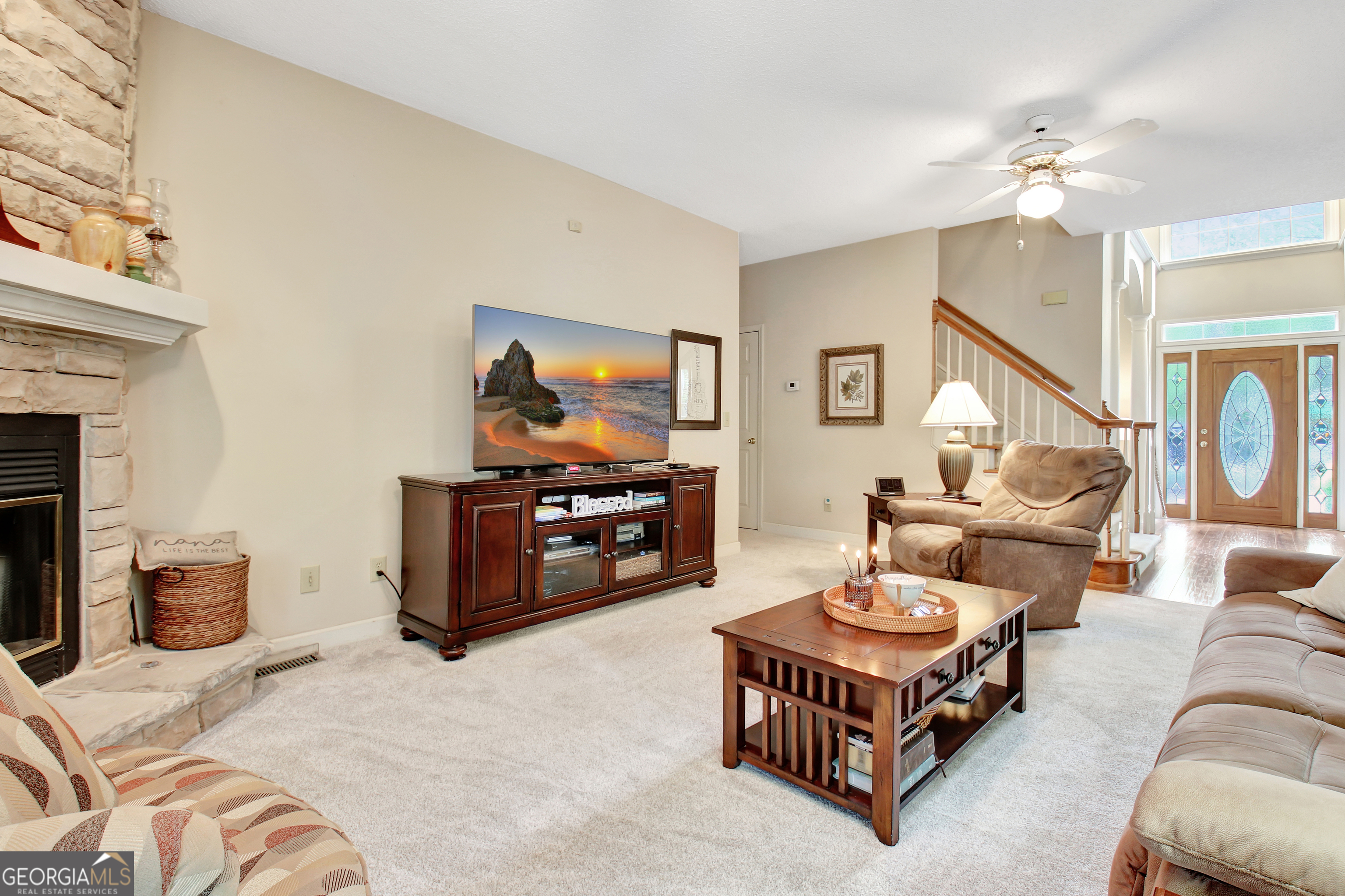 110 Sunset Court Senoia, GA 30276 - Photo 30 of 118 a living room with furniture and a flat screen tv