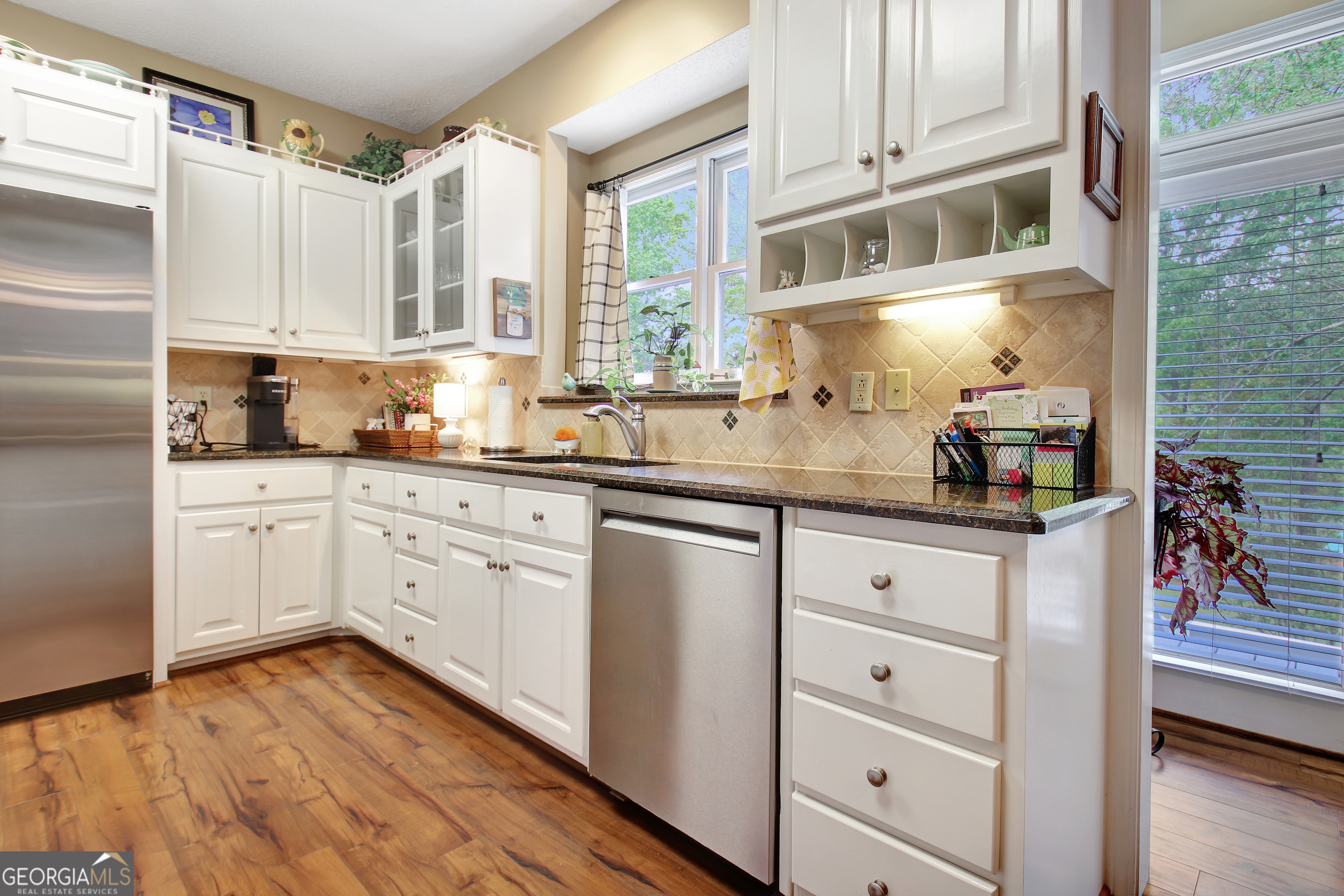 110 Sunset Court Senoia, GA 30276 - Photo 40 of 118 a kitchen with stainless steel appliances granite countertop a sink and cabinets
