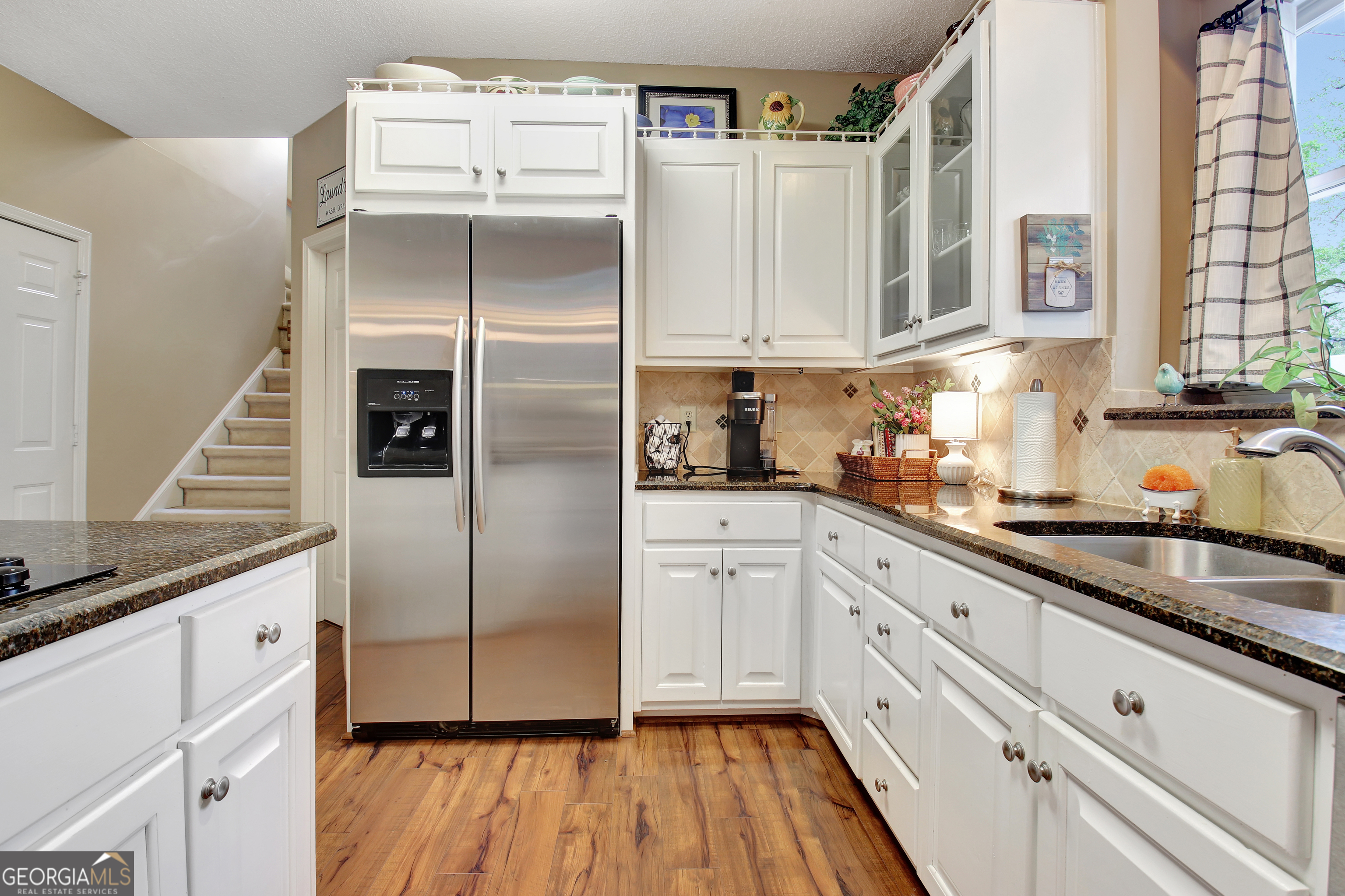 110 Sunset Court Senoia, GA 30276 - Photo 41 of 118 a kitchen with stainless steel appliances granite countertop a refrigerator and cabinets