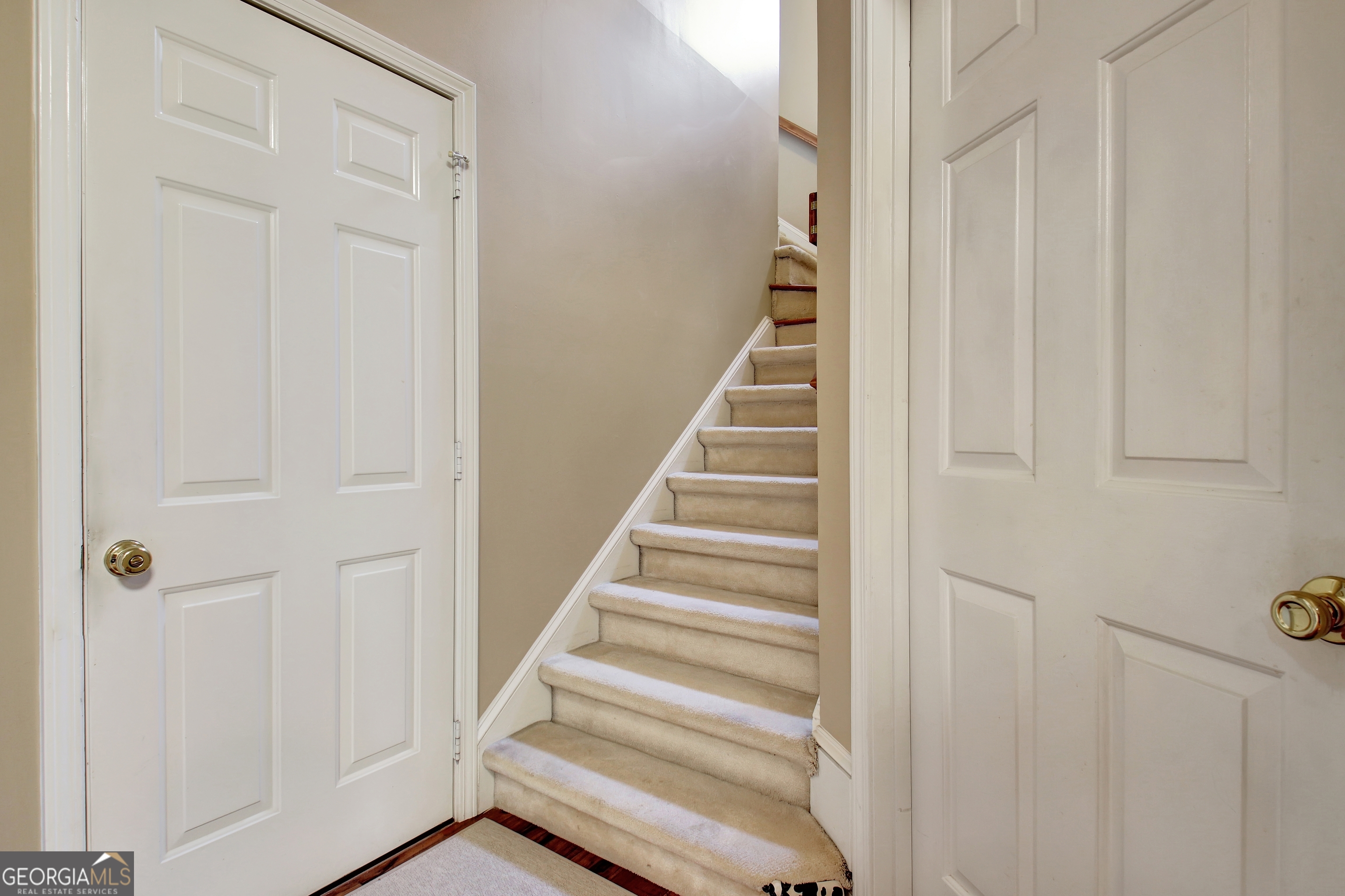 110 Sunset Court Senoia, GA 30276 - Photo 45 of 118 a view of staircase with white walls and white door