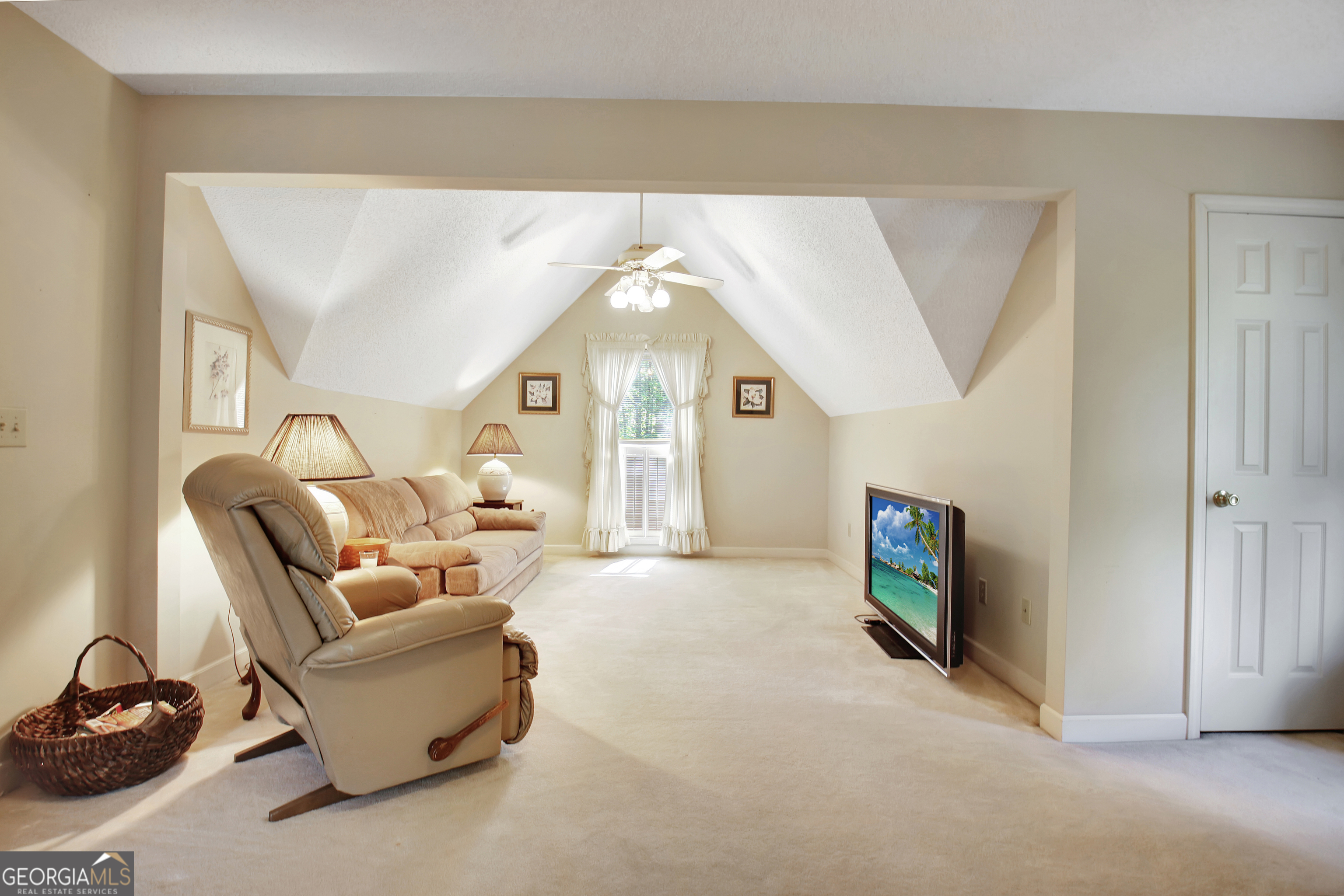 110 Sunset Court Senoia, GA 30276 - Photo 68 of 118 a living room with furniture a fireplace and a flat tv screen next to a window