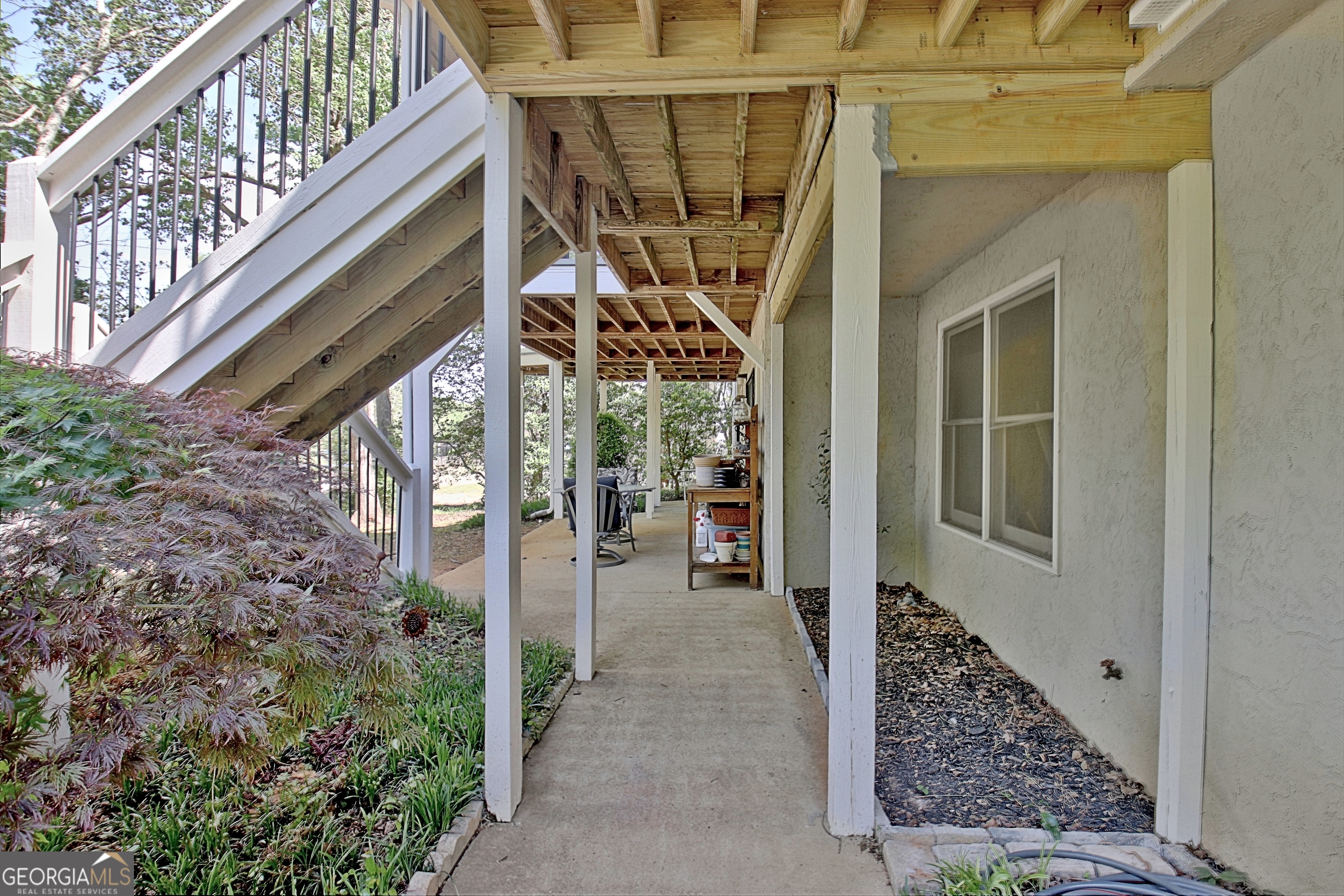 110 Sunset Court Senoia, GA 30276 - Photo 100 of 118 a view of a porch with a floor to ceiling window and wooden fence