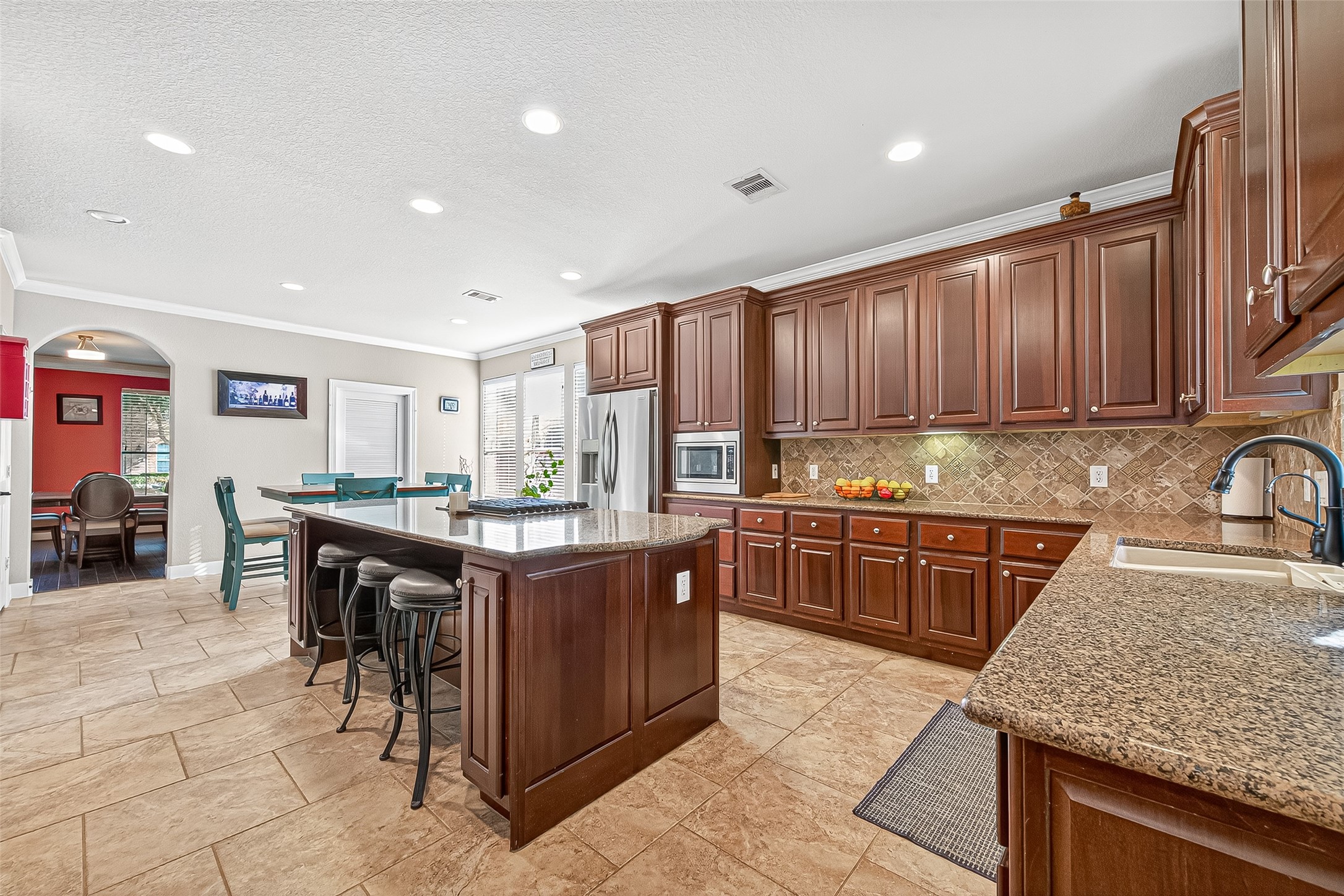 1206 Coleridge Street Sugar Land, TX 77479 - Photo 23 of 46 a kitchen with stainless steel appliances granite countertop wooden cabinets a stove top oven a sink and dishwasher