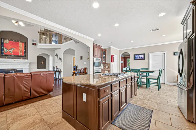a living room with lots of furniture and wooden floor