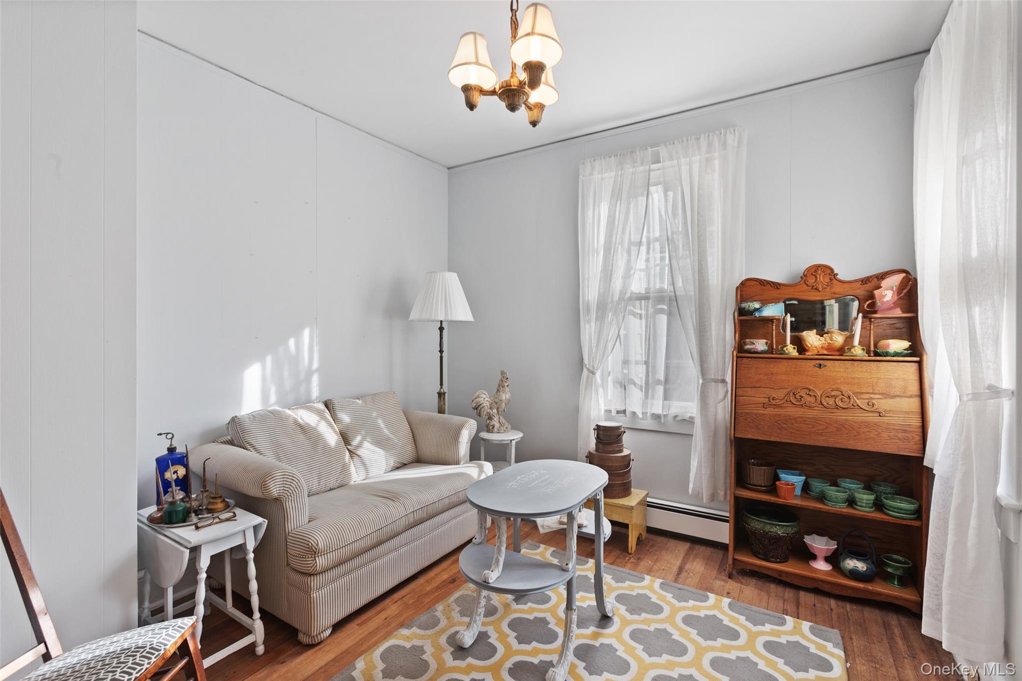 1753 Lawrence Road Mohegan Lake, NY 10547 - Photo 16 of 33 a living room with furniture a rug and a chandelier