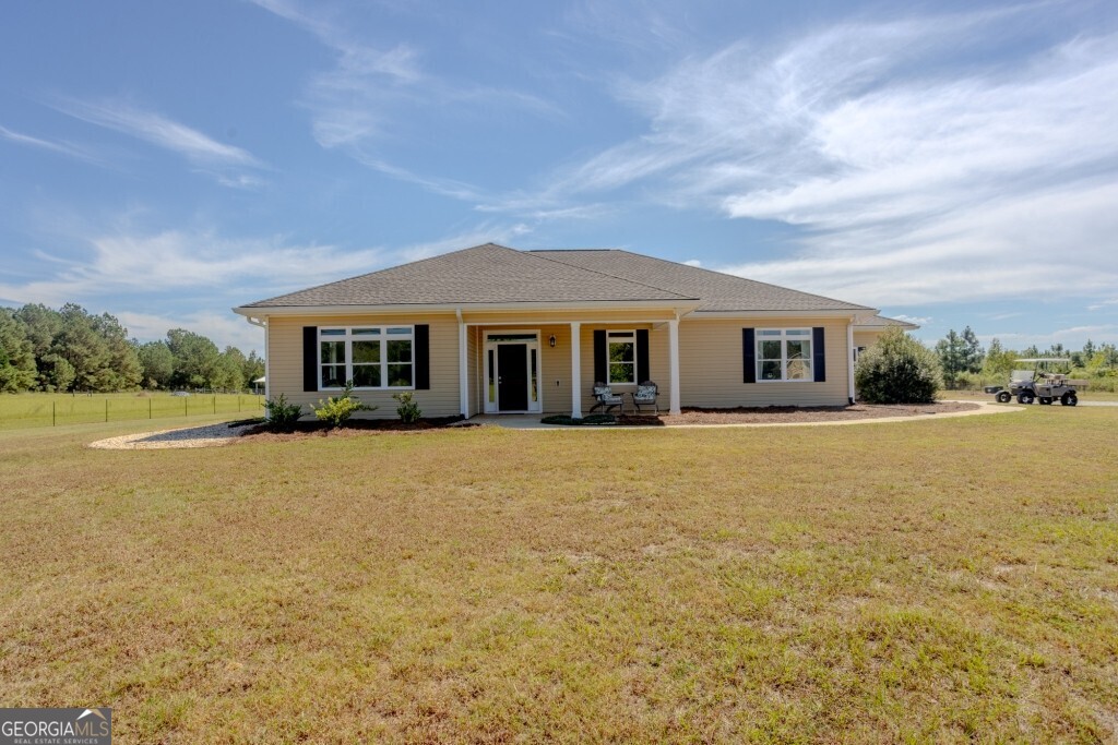 2160 Wall Road Dexter, GA 31019 - Photo 1 of 1 a front view of a house with a yard