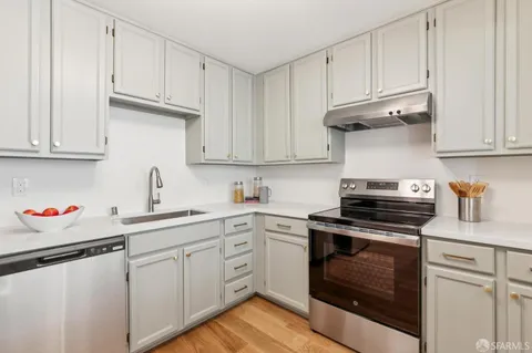 a kitchen with cabinets appliances and a sink