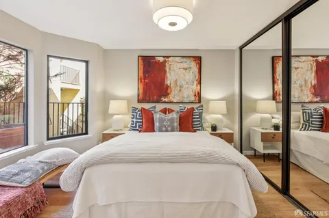 a bedroom with a large bed and a large window