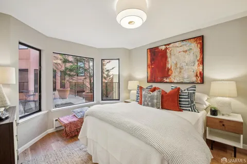 a bedroom with a bed and a large window