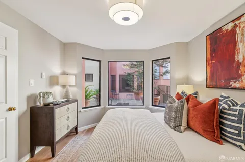 a spacious bedroom with a bed and window