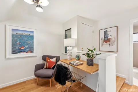 a dining room with furniture and wooden floor