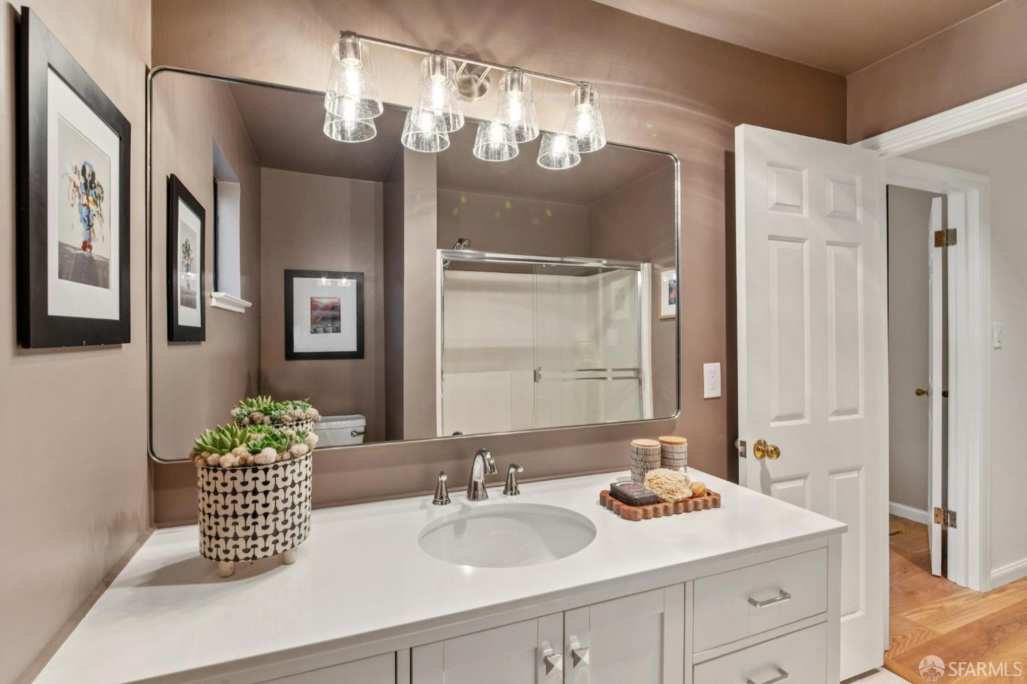 972 Haight Street San Francisco, CA 94117 - Photo 23 of 47 a bathroom with a sink a large mirror and a shower