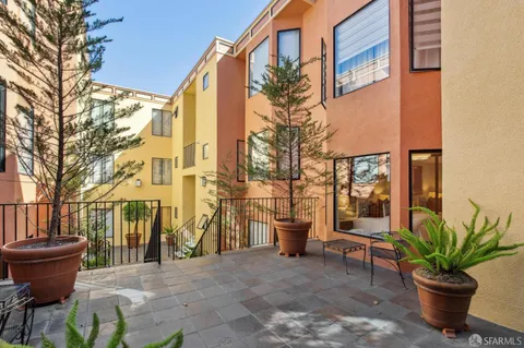 a backyard of a house with barbeque oven table and chairs