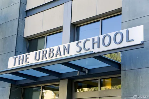 a group of people sitting in front of a store
