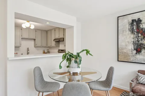a dining room with furniture and wooden floor