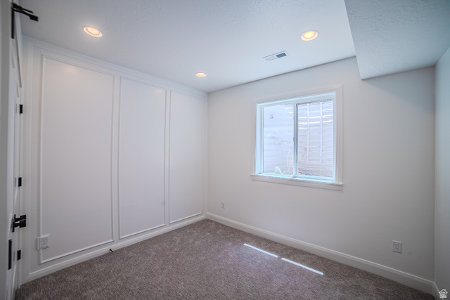 45 North Scarlet Maple Road, Unit 4317 Vineyard, UT 84059 - Photo 33 of 35 Bright interior space featuring recessed lighting, a window with exterior grating, and textured carpeting
