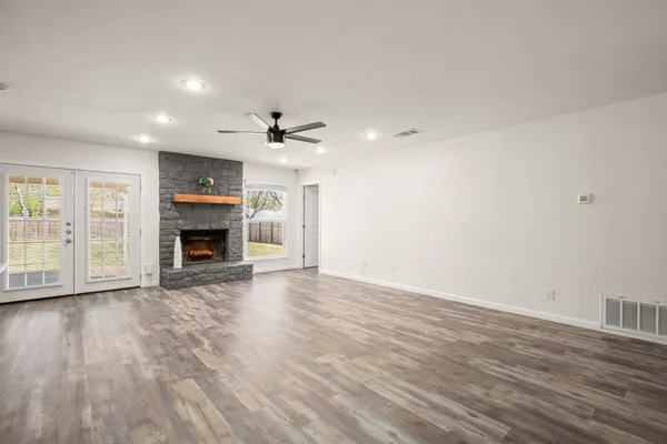 wooden floor in an empty room with a fireplace