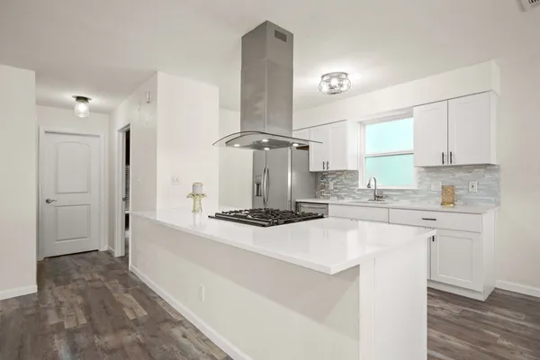 a kitchen with stainless steel appliances granite countertop a sink and a stove