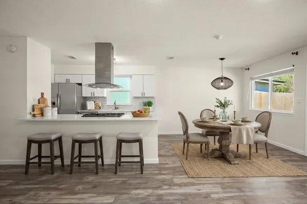 a dining room with granite countertop furniture and wooden floor